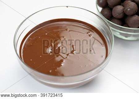 Closeup Dark Or Milk Melted Chocolate In Glass Bowl Isolated On White Background. Organic Couverture