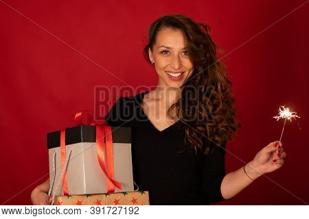 Cheerful Attractive Woman Celebrating New Year, Christmas, Hanukkah, Kwanzaa Holiday. Lady With Gift