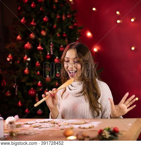 Cute Long-haired Brunette Girl Sings Using Wooden Spatula Instead Of Microphone Making Christmas Gin