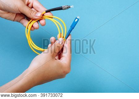Womans Hands Hold Sc And Fc Connector Fiber Optic Patch Cord Single Mode On Blue Background