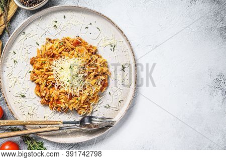 Orzo Pasta, Risone With Bolognese Sauce And Ground Beef In A Plate. Gray Background. Top View. Copy 
