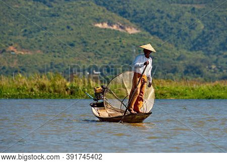 Nanthe. Myanmar. November 27, 2016. Clownfishermen On Inle Lake Pose In Front Of Tourist Photographe