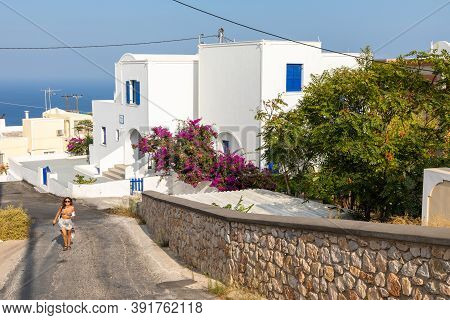 Thira, Santorini Island, Greece- 18 September 2020: Woman Walked On A Narrow Side Street In Thira Th
