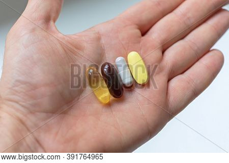 Vitamins Minerals And Supplements Pills In Hand