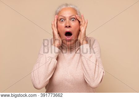Amazed Elderly Woman Looking Surprised And Shocked.