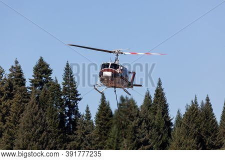 Prospect,  Oregon / Usa - September 9, 2014:  A Fire Fighting Helicopter Pilot Looks Out His Window 
