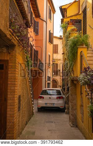 Modern Cars On Street Of  Medieval Town Of Orte In Italy.