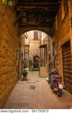 Modern Cars On Street Of  Medieval Town Of Orte In Italy.