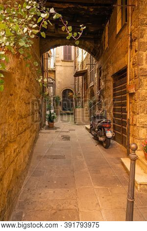 Modern Cars On Street Of  Medieval Town Of Orte In Italy.