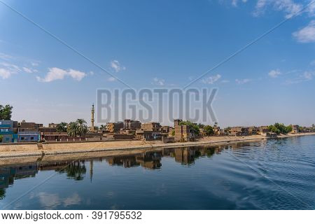 Traditional Egyptian Villages On The Bank Of The River Nile. Views Sailing On The Cruise On The Rive