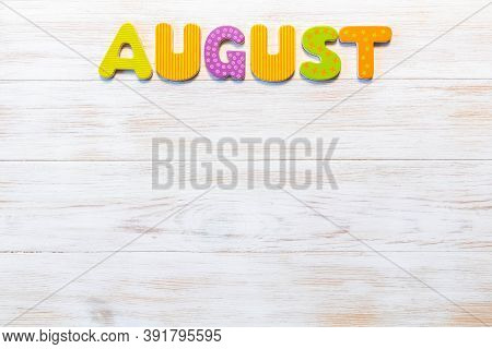 Wooden Letters Written August Month On Vintage Background. Inscription August With Copy Space. Top V