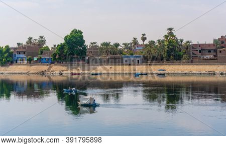 Traditional Egyptian Villages On The Bank Of The River Nile. Views Sailing On The Cruise On The Rive