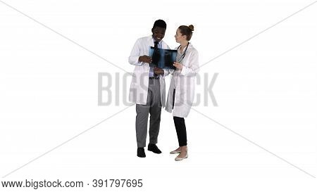 Young Female Doctor And Afro American Doctor Looking At The X-ra