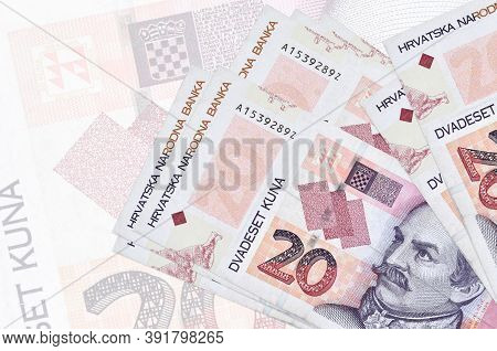20 Croatian Kuna Bills Lies In Stack On Background Of Big Semi-transparent Banknote. Abstract Presen