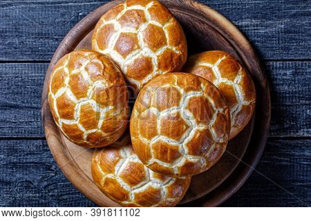 Asian Cuisine: Chinese Pineapple Buns - Soft And Fluffy Milk Buns Served On A Round Cutting Board On