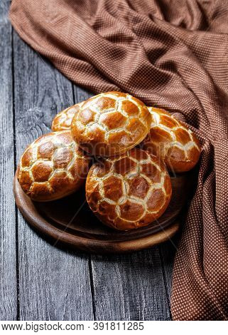 Asian Cuisine: Chinese Pineapple Buns - Soft And Fluffy Milk Buns Served On A Round Cutting Board On