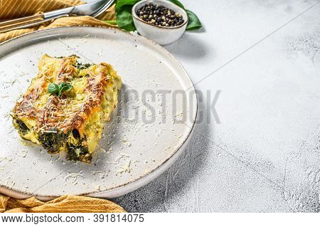 Baked Stuffed Vegetarian Pasta Cannelloni With Broccoli, Spinach, Basil And Cheese. Gray Background.
