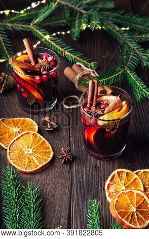 Christmas Mulled Wine With Cranberries, Orange And Spices On Rustic Wooden Background. Traditional H