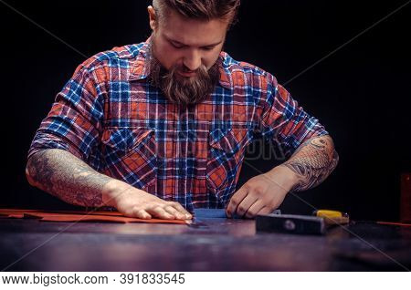 Leather Skinner Creating New Leatherwork At His Workshelf