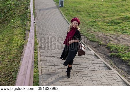 A Happy Lady Is Walking Up The Stairs, Both In Burgundy Palette And Biret, An Adult With Beautiful E