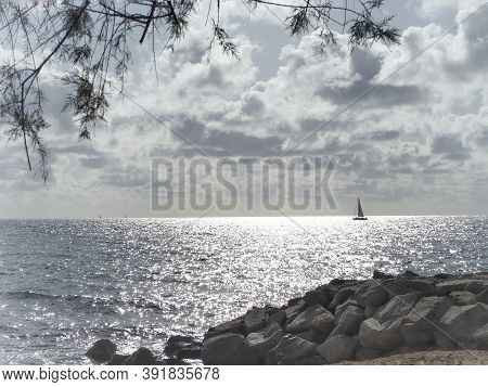 Barcelona Skyline And Sailingboat In Mediterranean Sea