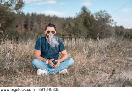 Brutal Vape Man Releases A Cloud Of Steam. Modern Ways Of Quitting Tobacco.