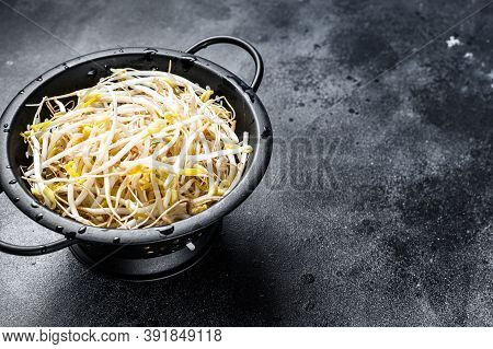 Sprouts Of Sprouted Beans In A Colander. Vegetarian Food. Black Background. Top View. Copy Space.