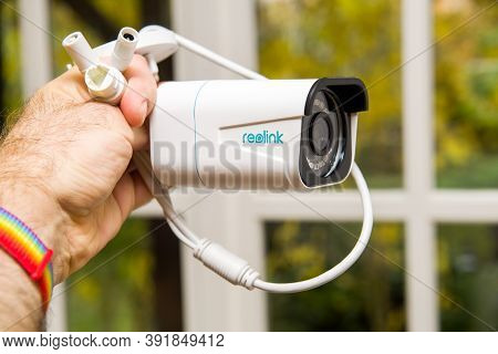 Paris, France - Oct 24, 2020: Pov Male Hand Holding Against Window Background New Reolink Cctv Surve