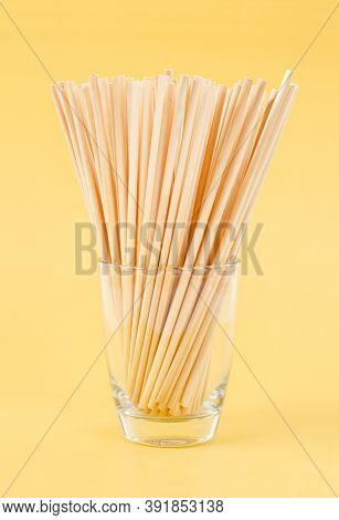 Wheat Straws For Drinking Water Natural Eco Friendly Renewable In Glass On Yellow Background.
