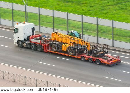 Truck With A Trailer Platform Transports Equipment With An Elevator Car Platform, Hydraulic And Mech