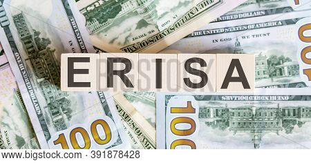 Concept Words Erisa On Wooden Blocks On A Beautiful Background From Dollar Bills. Business