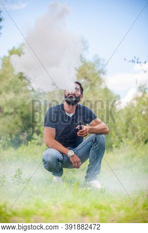Stylish Brutal Man Blows Up A Couple An Electronic Cigarette. Electronic Cigarette As Alternative To