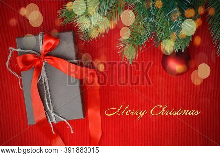 Spruce Green Branches On A Red Background And Red Ball, Christmas Toy. Happy New Year And Merry Chri