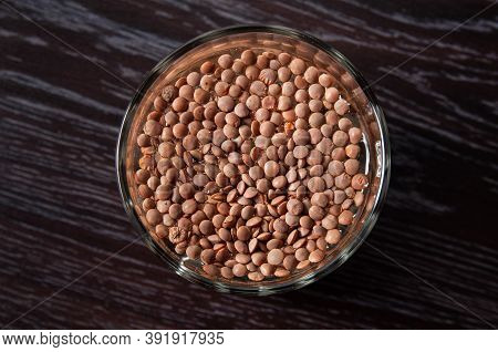 Top View On The Lentils Are Soaked In A Glass Of Water. Preparation For Sprouting Lentils