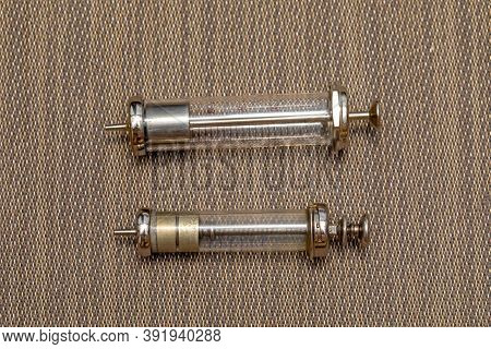 Two Big Old Reusable Glass Syringes Devices