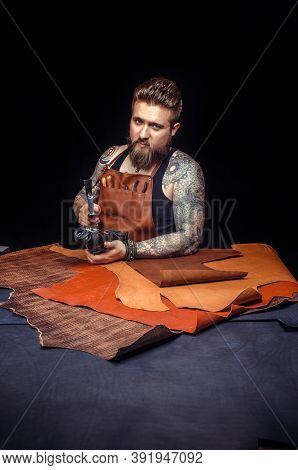 Handyman Processing A Leather Workpiece At The Tanning Shop
