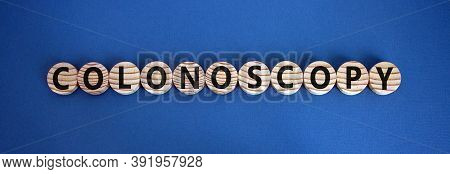 Wooden Circles With Word 'colonoscopy'. Beautiful Blue Background. Medical Concept. Copy Space.