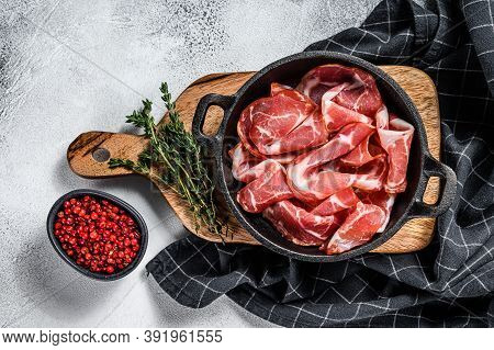 Italian Rolled Bacon Pancetta Piacentina. Pork Meat. White Background. Top View