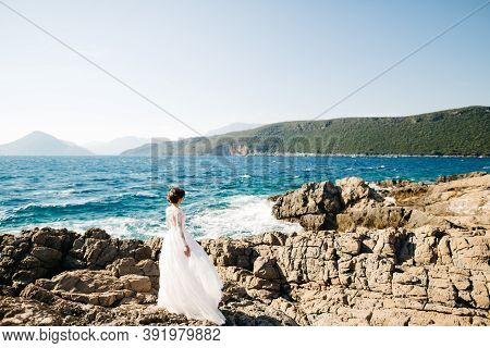 Beautiful Bride In Tender Wedding Dress On The Rocky Beach Of The Mamula Island