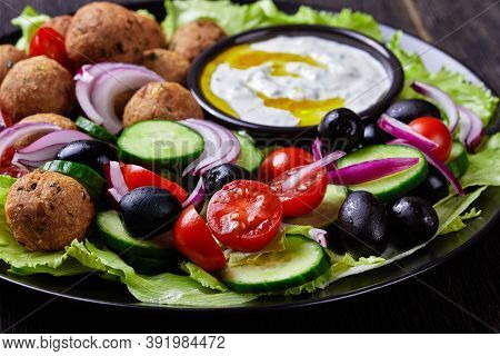 Mediterranean Platter Of Falafels, Tomatoes, Cucumber, Red Onion, Black Olives, On The Fresh Salad L