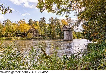 Wooden Cottage On Abandoned Bridge Pillar In Autumn Sunny Day