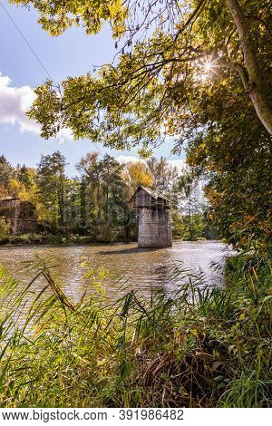 Wooden Cottage On Abandoned Bridge Pillar In Autumn Sunny Day