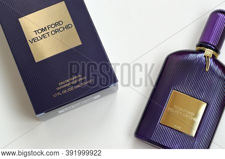 Tom Ford Velvet Orchid Fragrance Perfume Bottle Lies On Light Lilac Background. Tom Ford Is American