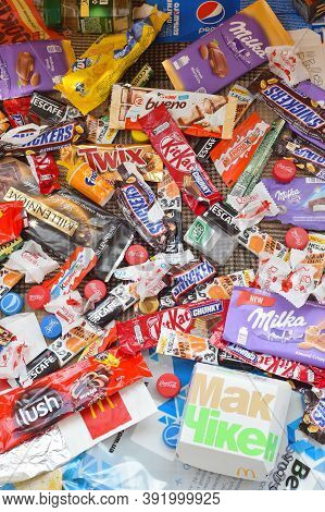 Many Wrappings And Cans From Used Products By Famous Worldwide Brands. Pattern Of Trash Of Various C
