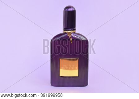 Tom Ford Velvet Orchid Fragrance Perfume Bottle Lies On Light Lilac Background. Tom Ford Is American
