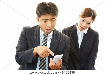 Surprised businessman and businesswoman