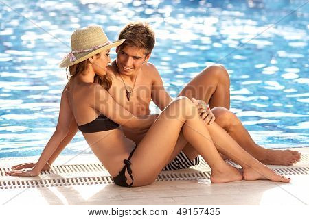 Attractive Couple At The Edge Of A Pool