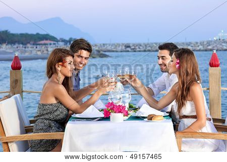 Friends Celebrating At A Seaside Restaurant