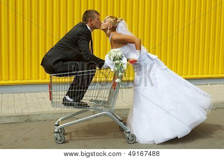 Bride And Groom Playing With A Basket Of Supermarket