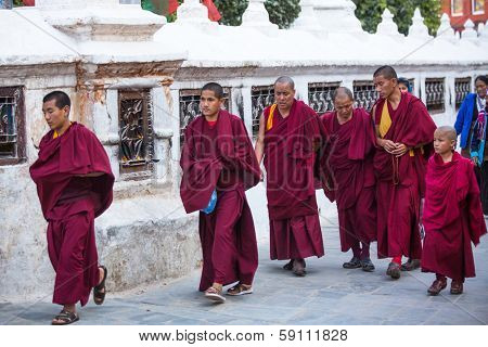 KATHMANDU, NEPAL - NOV 30: Unidentified monks circle Boudhanath, Nov 30, 2013 in Kathmandu, Nepal. Ancient Stupa is one of the largest in the world, of 1979 is a UNESCO World Heritage Site.